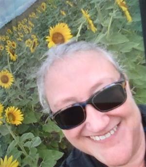 Picture of Mrs Avenevoli in a field of sunflowers 